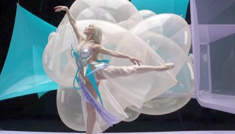 Performer within a sculptural composition of translucent white volumes, turquoise surfaces and violet architecture.